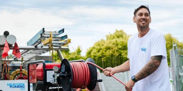 Smiling man with hose